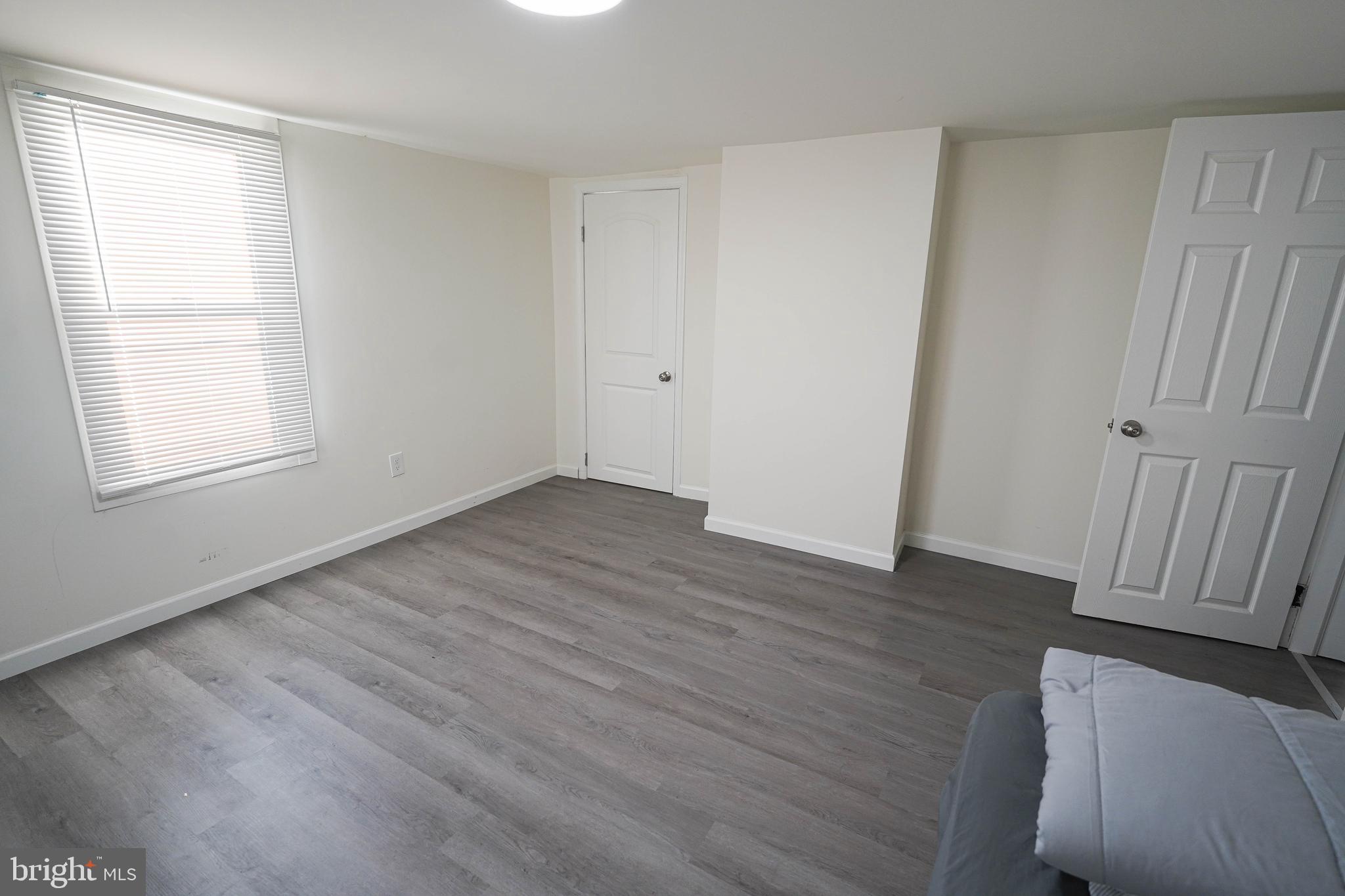 231 Newton Street, Unit B Salisbury, MD 21801 - Photo 17 of 31 an empty room with wooden floor and windows