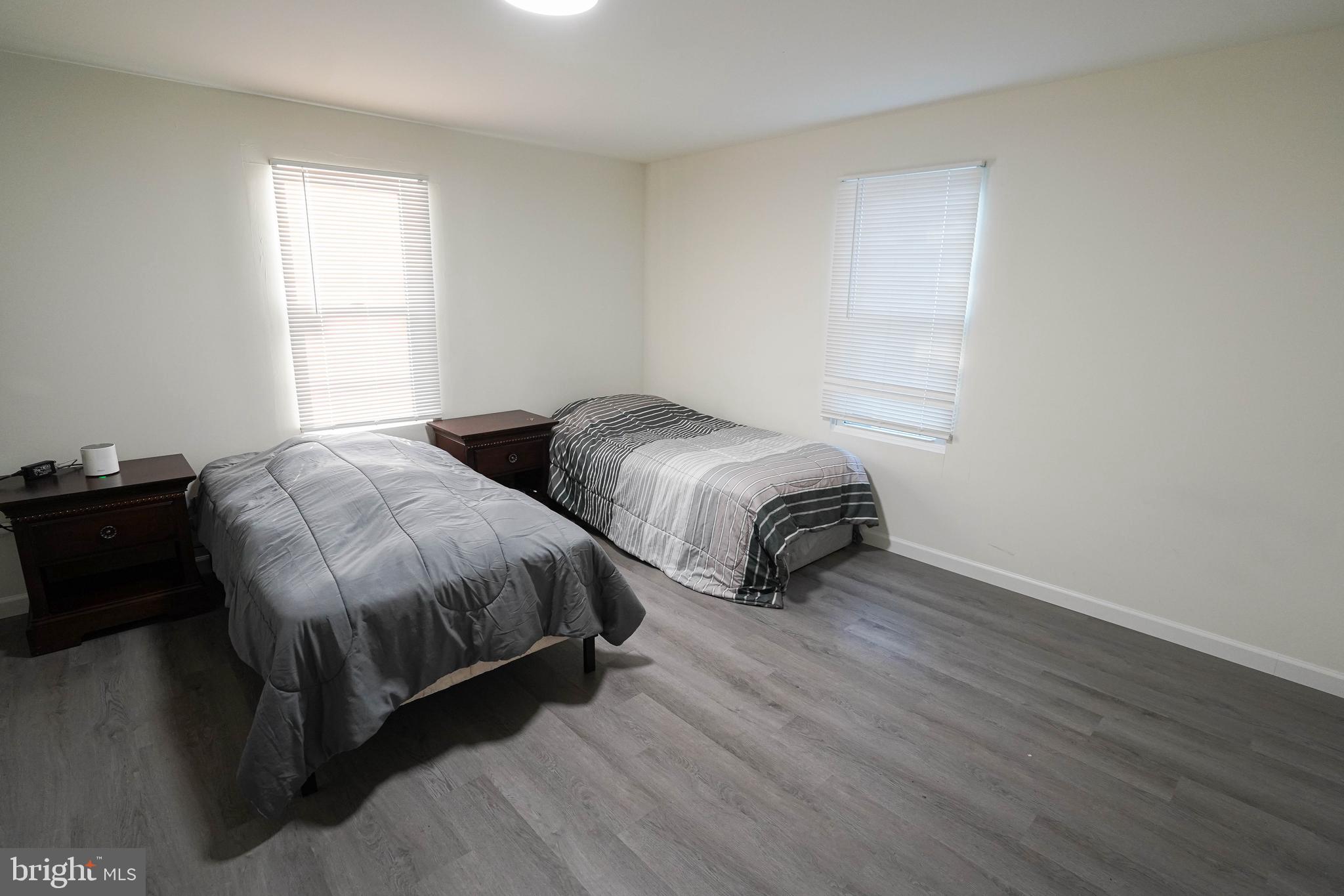 231 Newton Street, Unit B Salisbury, MD 21801 - Photo 24 of 31 a bedroom with two beds and a potted plant