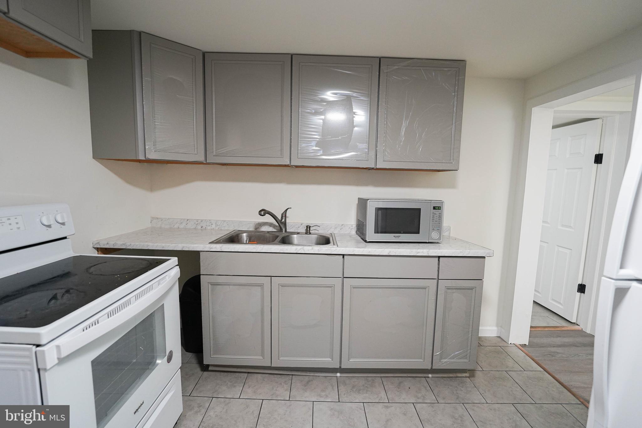 231 Newton Street, Unit B Salisbury, MD 21801 - Photo 27 of 31 a kitchen with a sink and cabinets