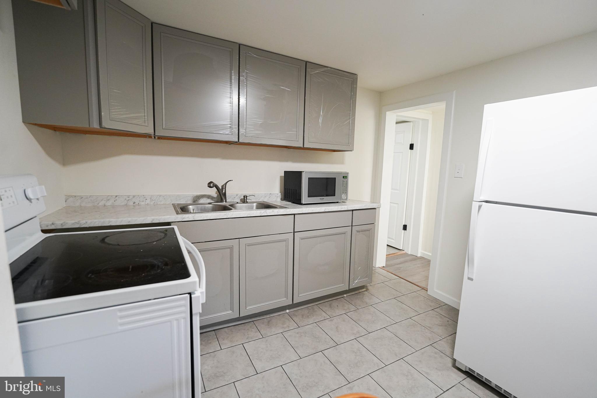 231 Newton Street, Unit B Salisbury, MD 21801 - Photo 28 of 31 a kitchen with a sink and cabinets