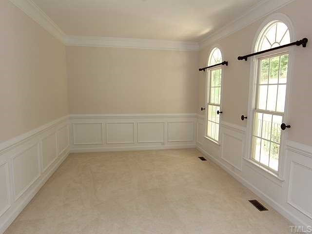 5204 6 Pence Court Raleigh, NC 27613 - Photo 2 of 17 Bright living room with lots of windows, heavy crown molding and wainscotting. Living Room