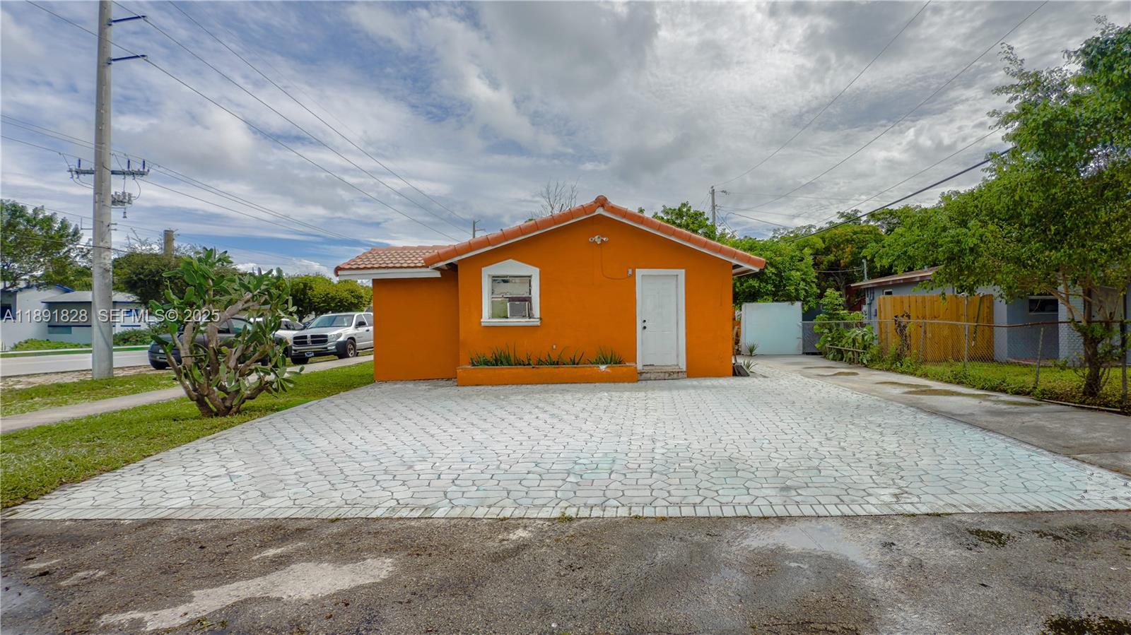 2112 Northwest 5th Street Pompano Beach, FL 33069 - Photo 2 of 3 a front view of a house with a yard