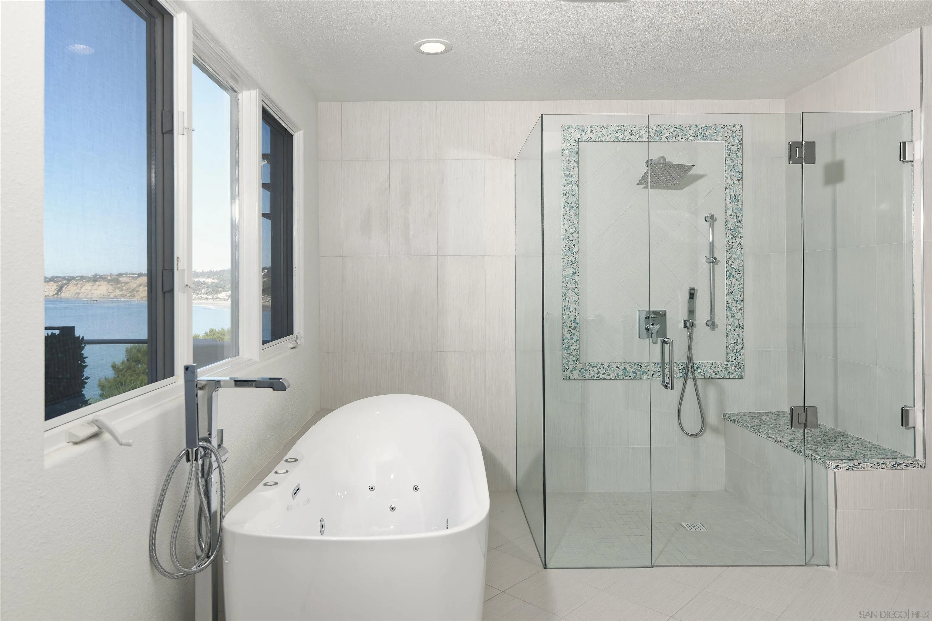 7825 Prospect Place La Jolla, CA 92037 - Photo 17 of 32 a bathroom with a bathtub and a shower