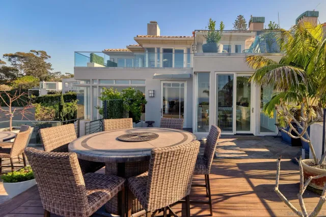 a view of a patio with table and chairs and potted plants