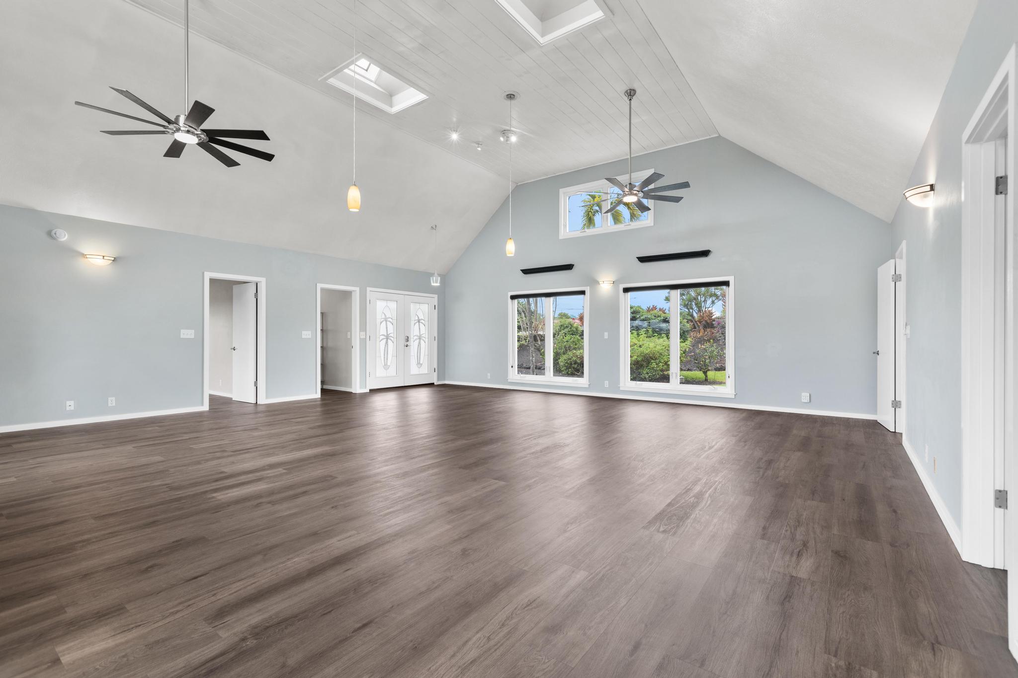 234 Kipa Street Hilo, HI 96720 - Photo 2 of 30 a view of an empty room with wooden floor and a window