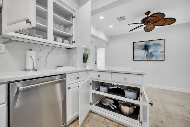 a kitchen with stainless steel appliances a stove and cabinets