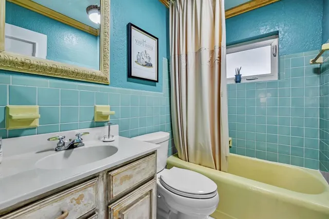 a bathroom with a sink mirror toilet and bathtub