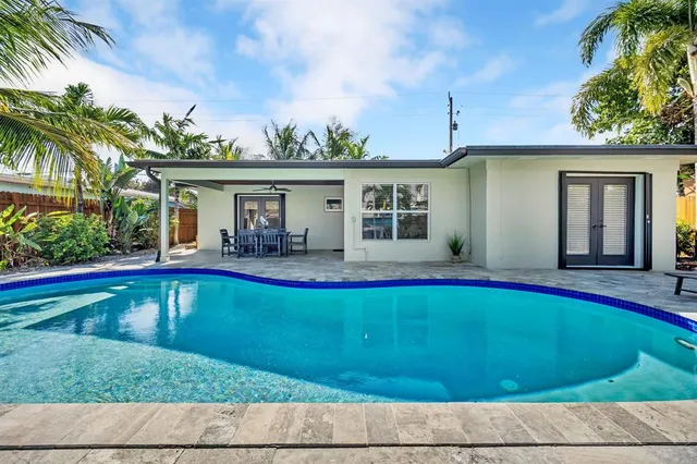 a view of house with swimming pool yard and outdoor seating