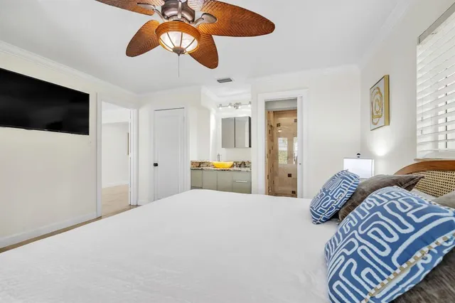 a bedroom with a bed and a chandelier