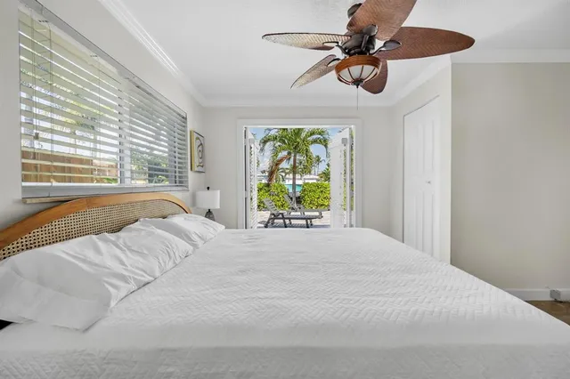 a bedroom with a bed mirror and window