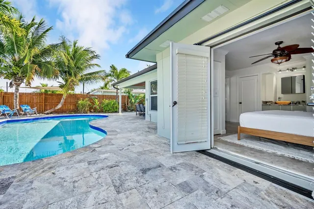a backyard of a house with barbeque oven table and chairs