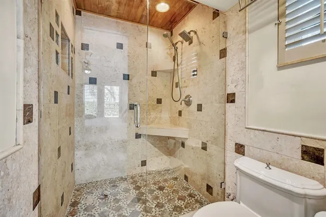 a bathroom with a toilet sink and shower