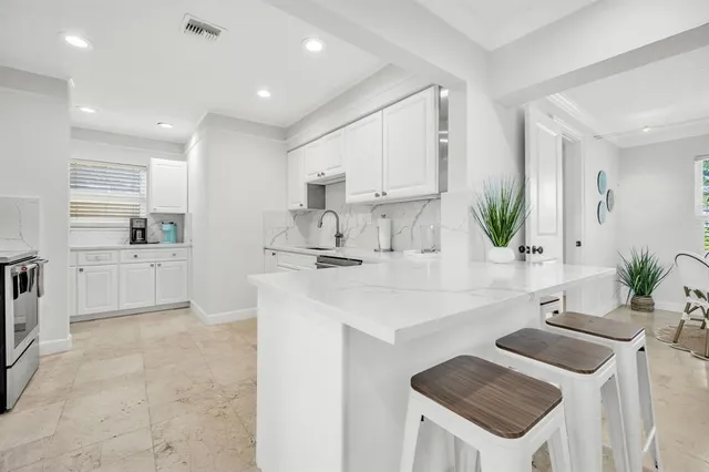 a kitchen with a sink and a refrigerator