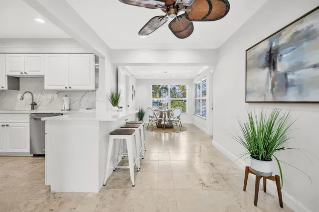 a kitchen with a dining table stainless steel appliances and cabinets