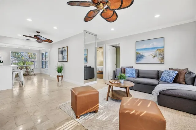 a living room with furniture a rug and a chandelier