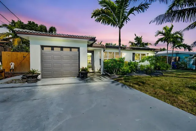a view of a house with garden and a yard