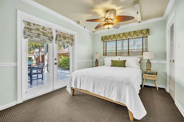 a bedroom with a large bed and a chandelier