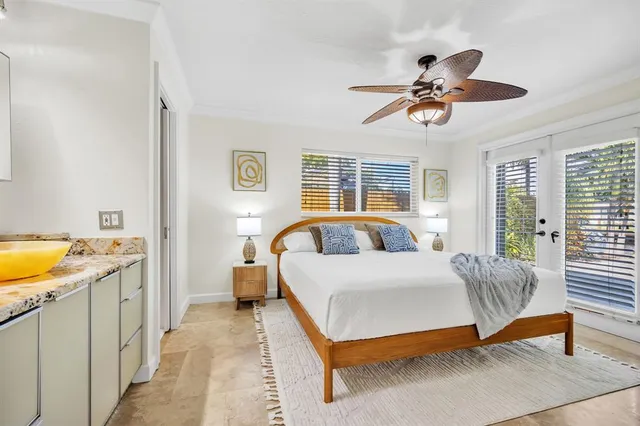 a spacious bedroom with a bed and a chandelier