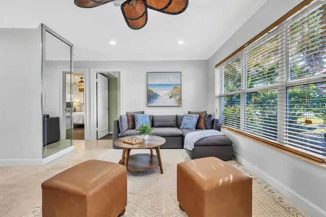 a living room with furniture and a large window
