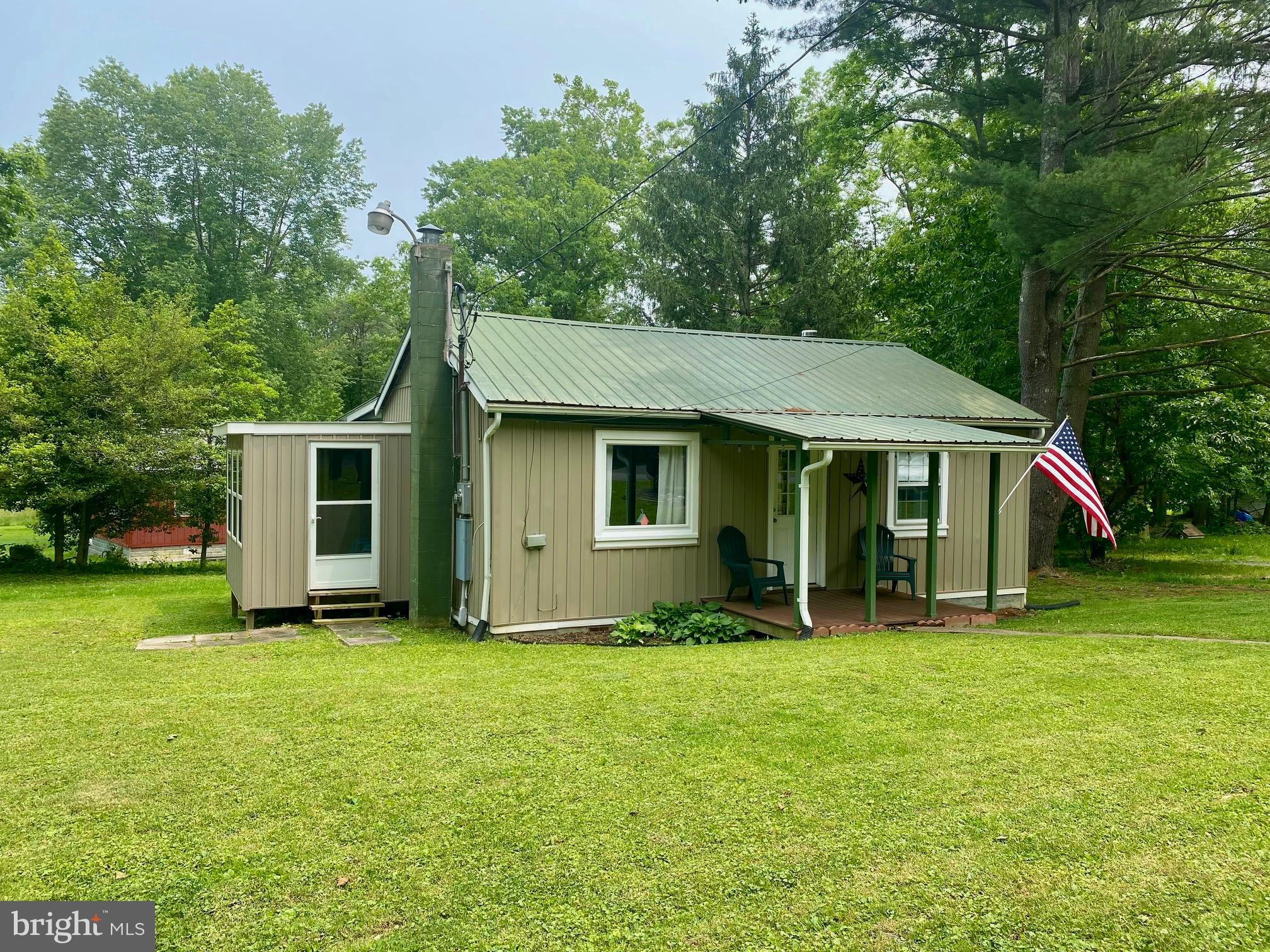 3815 Capon River Road Yellow Spring, WV 26865 - Photo 1 of 21 a front view of a house with a yard