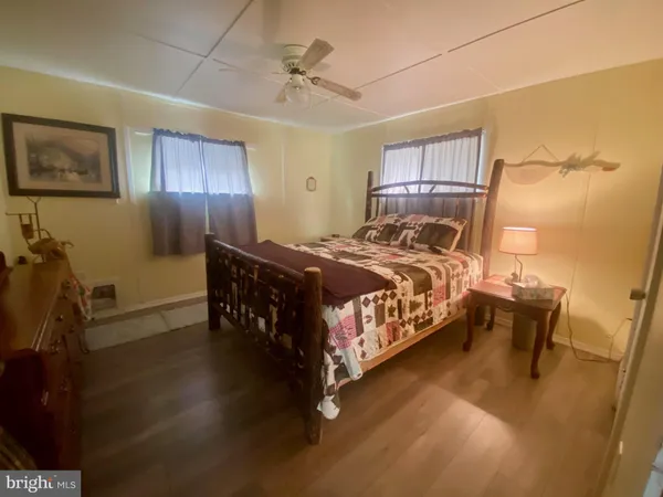 a bedroom with a bed table closet and a mirror