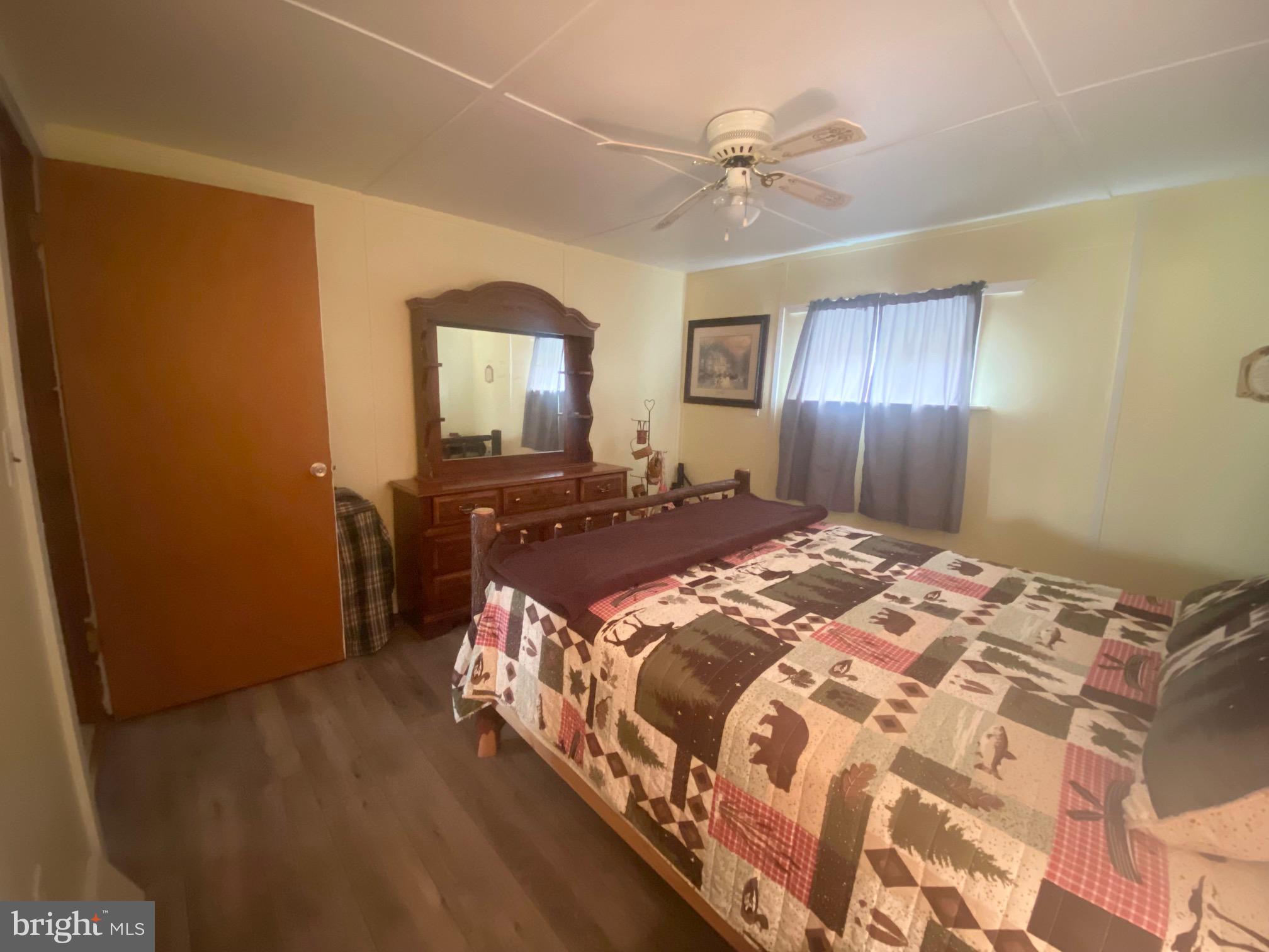 3815 Capon River Road Yellow Spring, WV 26865 - Photo 12 of 21 a bedroom with a bed and wooden floor