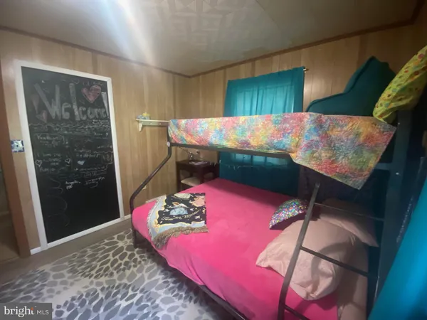 a bed room with a bed and a television