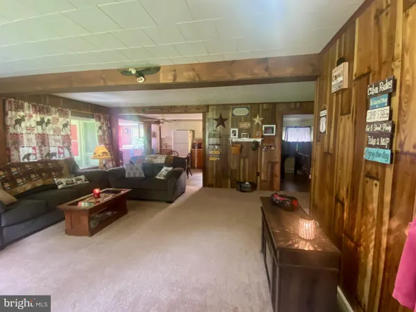 a living room with furniture gym equipment and a chandelier