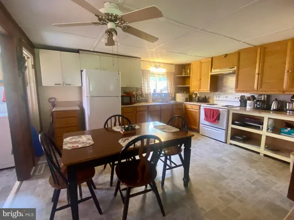 a view of a dining room with furniture and a chandelier