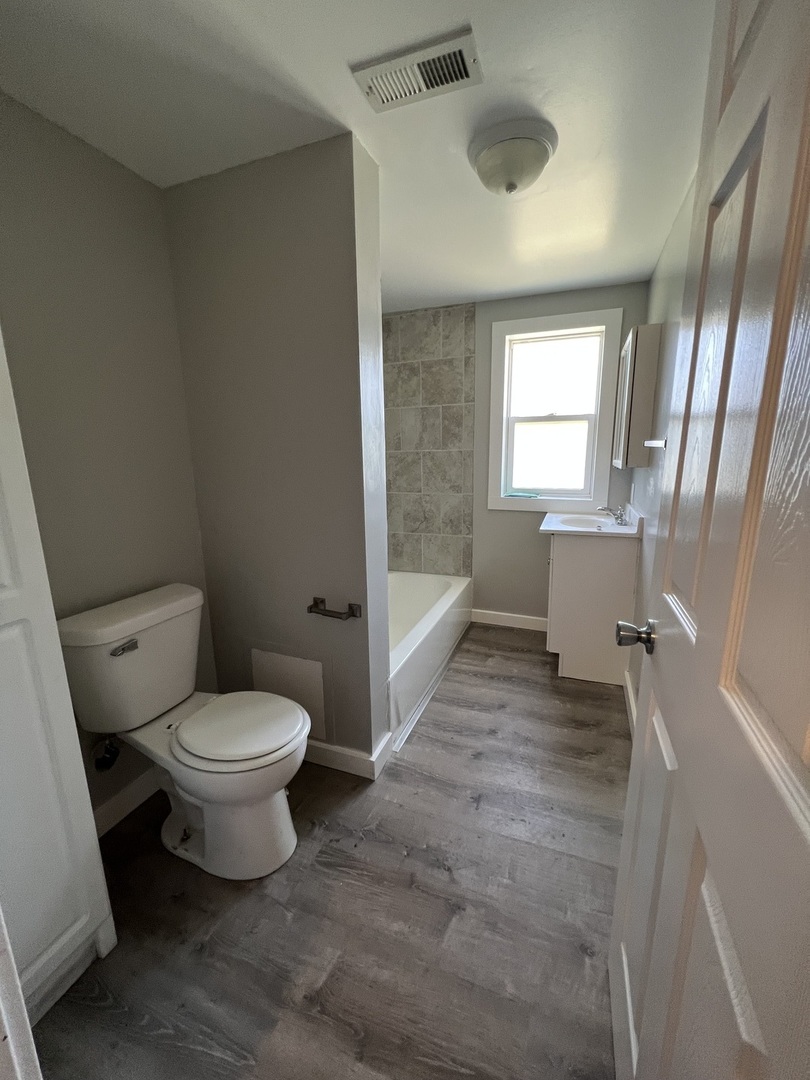 1013 Deephaven Drive Joliet, IL 60432 - Photo 14 of 17 a bathroom with a toilet sink and tub