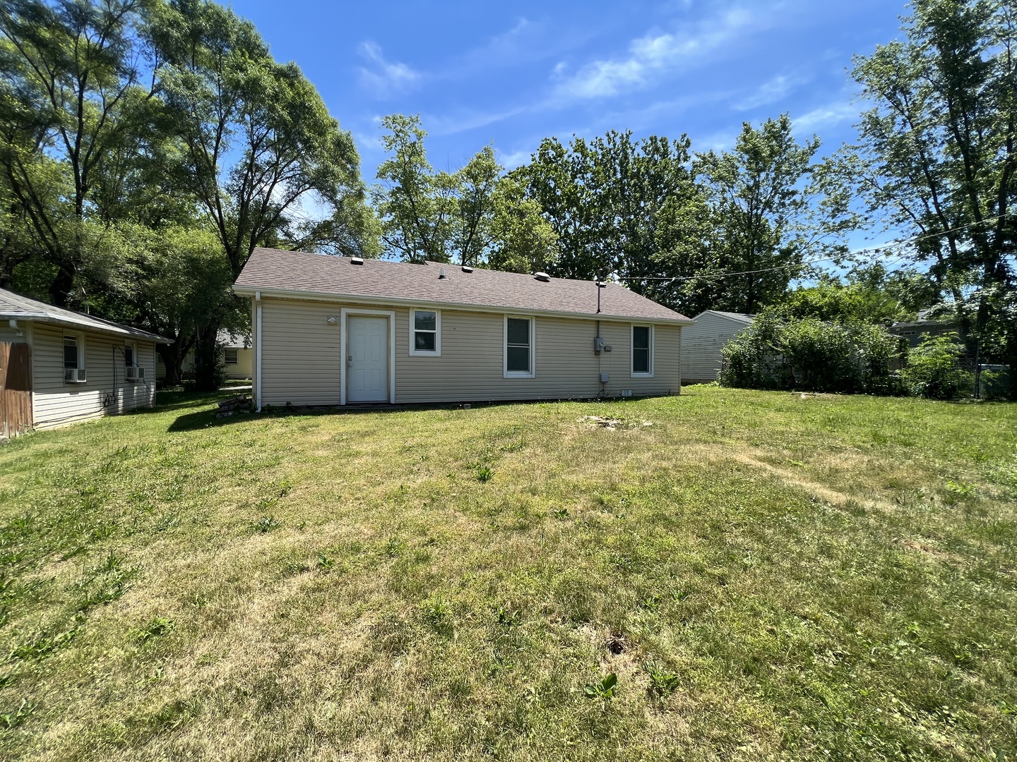 1013 Deephaven Drive Joliet, IL 60432 - Photo 16 of 17 a house with green field in front of it
