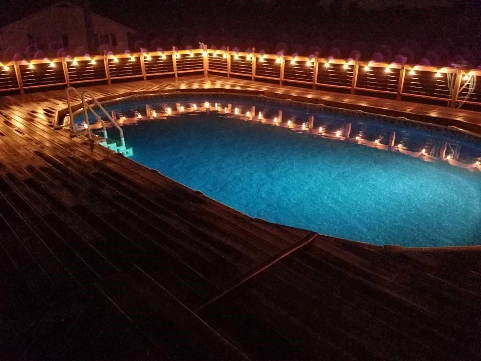 321 Madison Heights Road New Stanton, PA 15672 - Photo 22 of 24 pool in the back yard with large deck and lighting surrounding the pool.