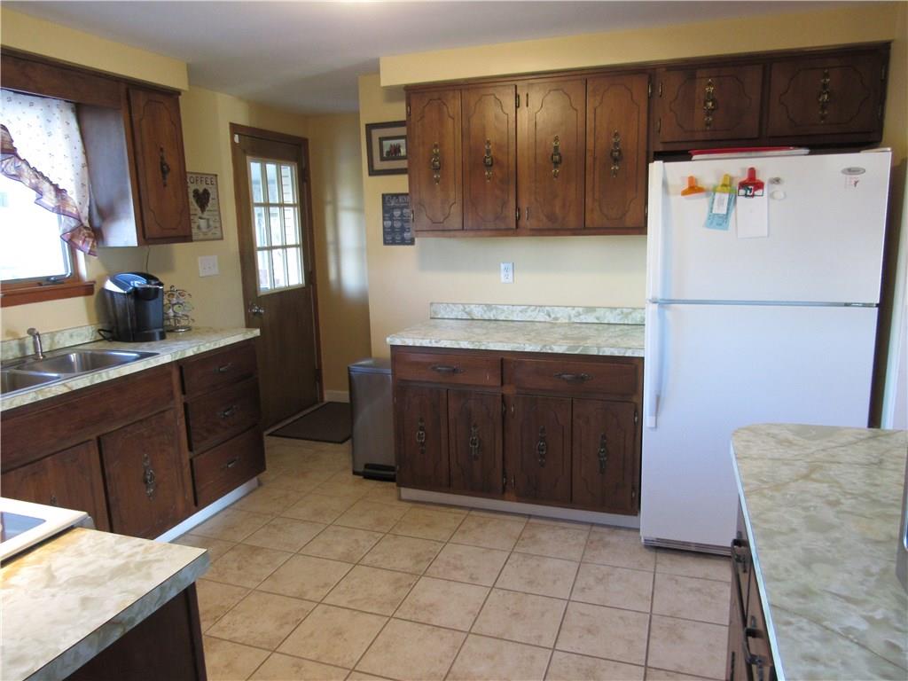 321 Madison Heights Road New Stanton, PA 15672 - Photo 10 of 24 kitchen with door leading to enclosed back porch that leads to pool/deck area