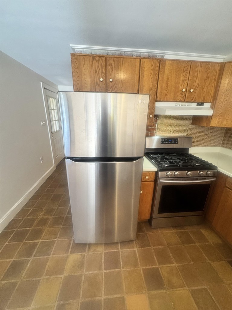 1723 Carleton Street Berkeley, CA 94703 - Photo 17 of 32 a kitchen with granite countertop a refrigerator and a stove