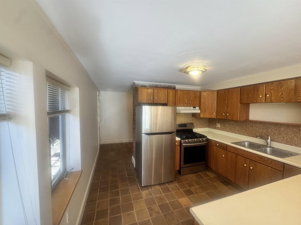 1723 Carleton Street Berkeley, CA 94703 - Photo 19 of 32 a kitchen that has a sink stainless steel appliances a counter space and a window