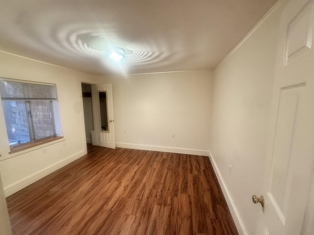 1723 Carleton Street Berkeley, CA 94703 - Photo 20 of 32 a view of an empty room with wooden floor and a window