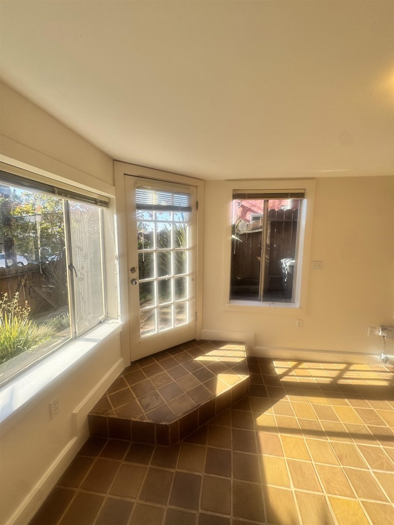 1723 Carleton Street Berkeley, CA 94703 - Photo 8 of 32 a view of a livingroom with wooden floor and a large window
