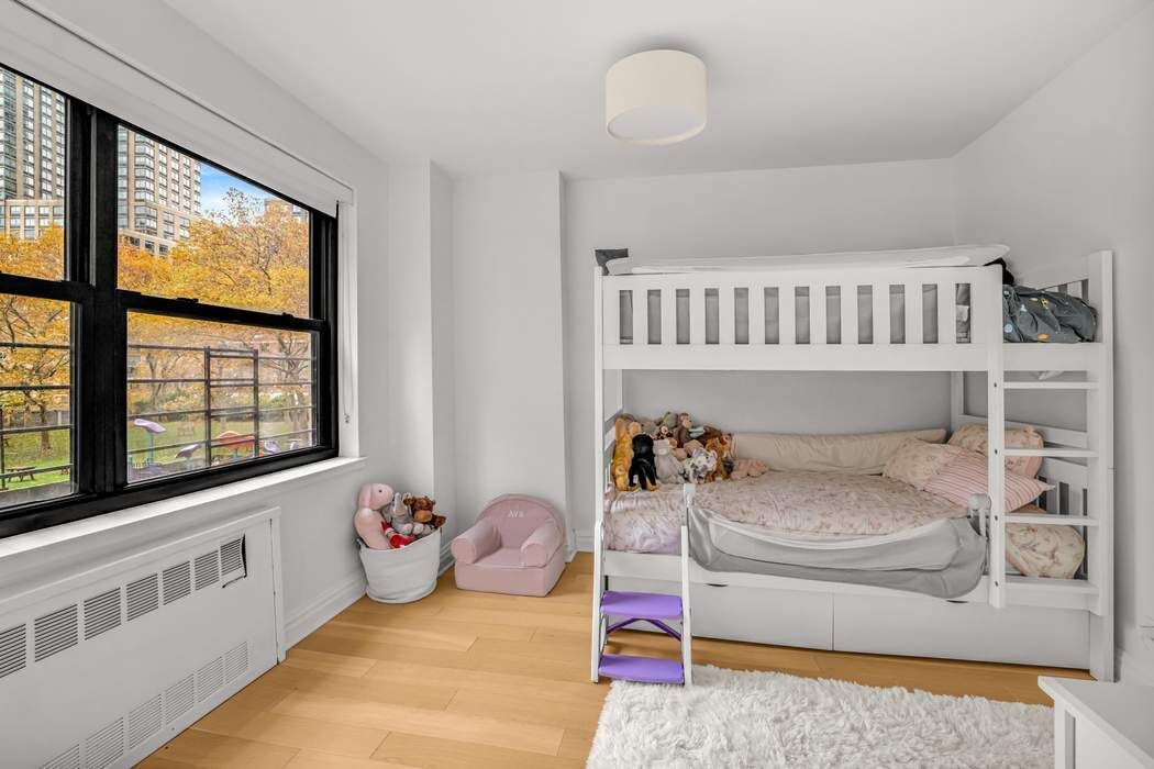 205 West End Avenue, Unit 2J Manhattan, NY 10023 - Photo 8 of 10 a bedroom with furniture and a window