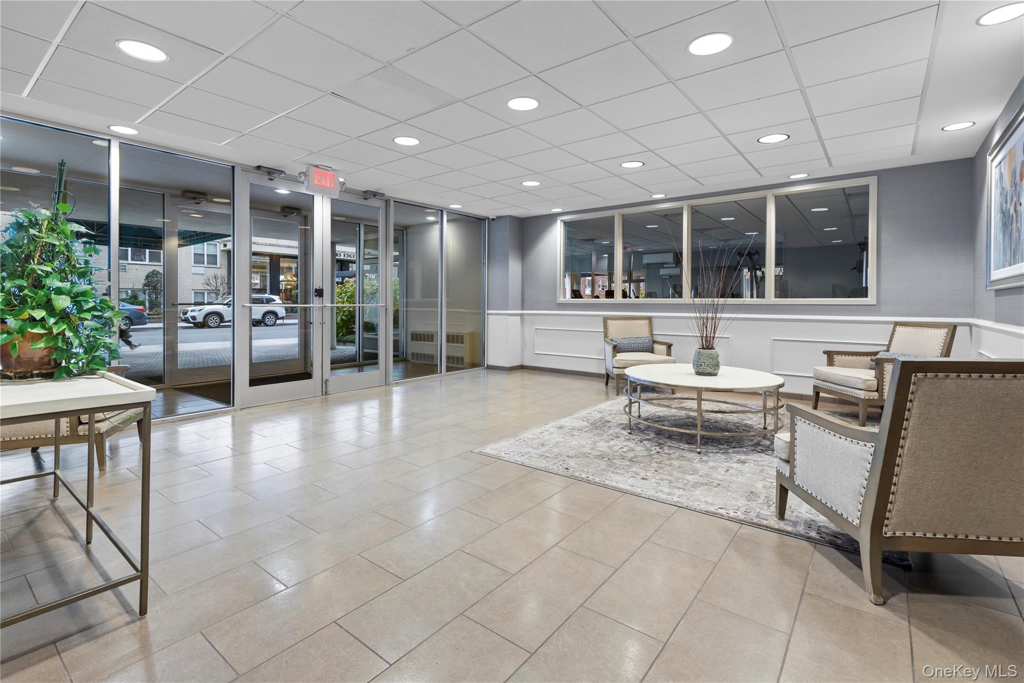 711 Shore Road, Unit 3B Long Beach, NY 11561 - Photo 14 of 20 Common area featuring a decorative wall, recessed lighting, and expansive windows