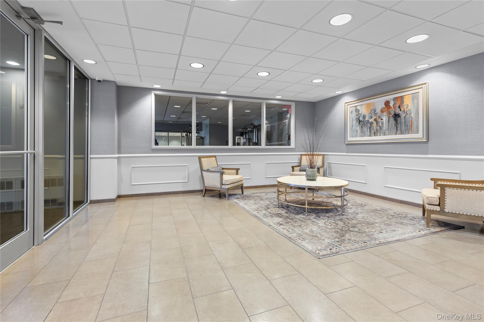 711 Shore Road, Unit 3B Long Beach, NY 11561 - Photo 15 of 20 Common area featuring a decorative wall, wainscoting, a paneled ceiling, and recessed lighting