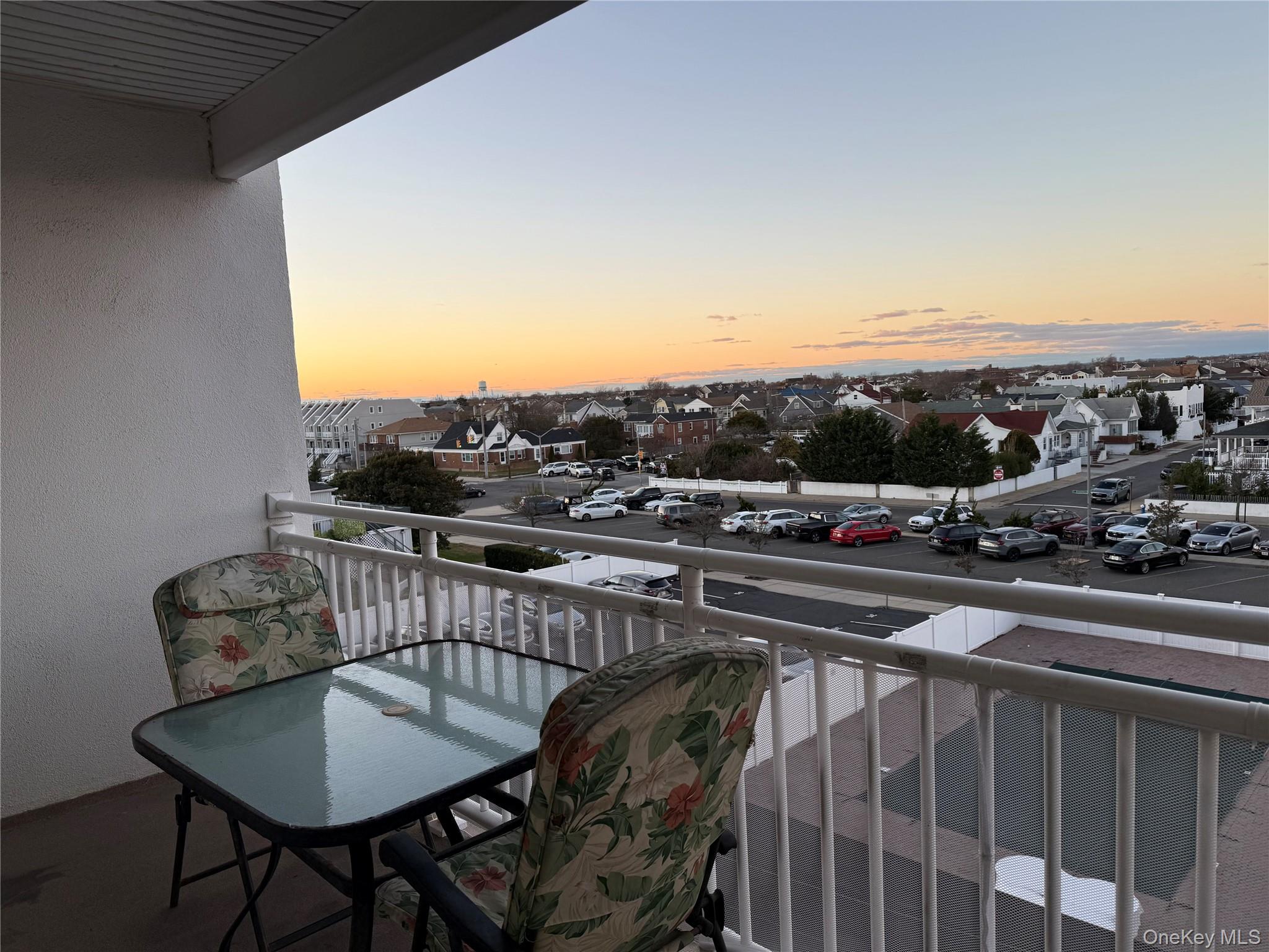 711 Shore Road, Unit 3B Long Beach, NY 11561 - Photo 17 of 20 Balcony at dusk with a residential view