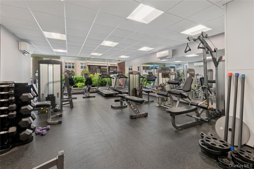 711 Shore Road, Unit 3B Long Beach, NY 11561 - Photo 19 of 20 Workout area with a drop ceiling and an AC wall unit