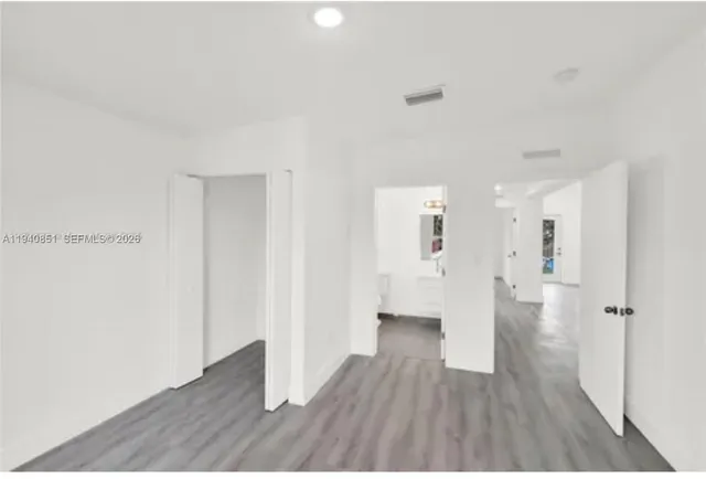 a kitchen with kitchen island a sink cabinets and stainless steel appliances