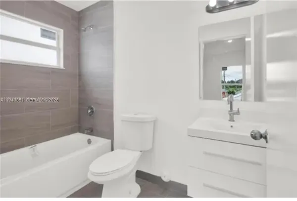 a kitchen with stainless steel appliances granite countertop a refrigerator a sink a stove a microwave and wooden cabinets