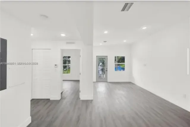 a view of backyard with potted plants and wooden fence