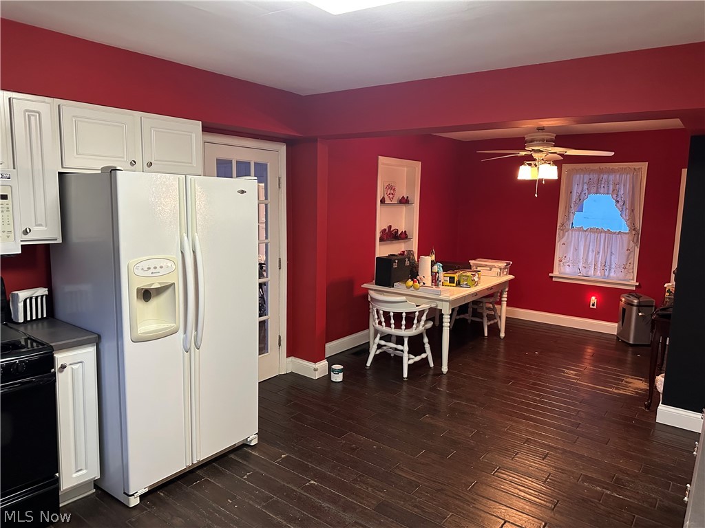 3192 Mogadore Road Akron, OH 44312 - Photo 12 of 43 Kitchen with white cabinets, white appliances, dark wood-style floors, and ceiling fan