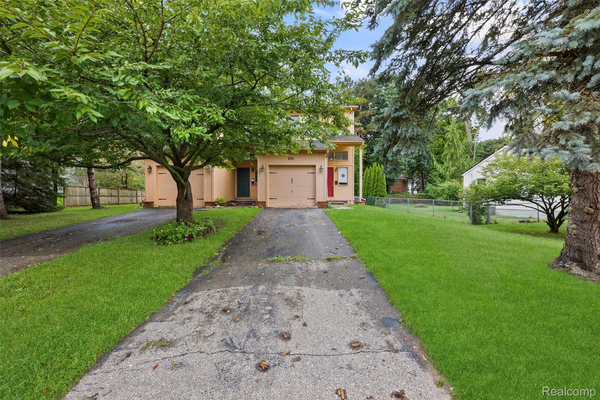 200 Fraser Street Rochester, MI 48307 - Photo 23 of 29 Exterior featuring a light-colored facade, attached garage, and mature trees