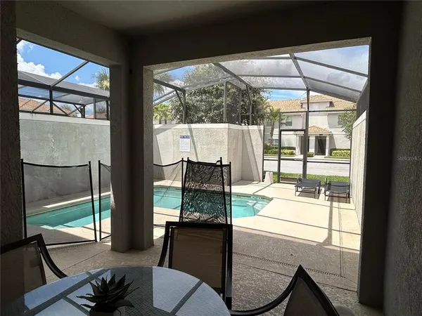 a dining room with glass top table and chairs