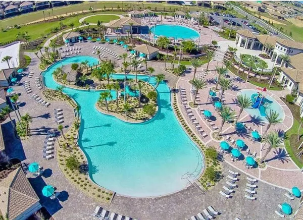an aerial view of a swimming pool patio yard and outdoor seating