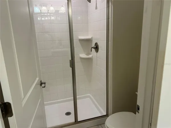 a bathroom with a glass shower door